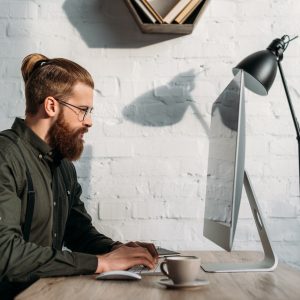 side view of handsome businessman using computer in office